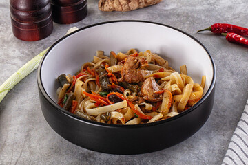 Asian cuisine udon with chicken and vegetables