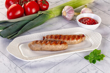 Grilled pork sausages served tomato sauce
