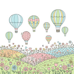 Colorful hot air balloons floating above a vibrant flowery landscape.