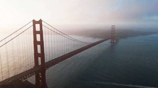 Drone shot of Golden Gate Bridge at dawn during a cloudy day