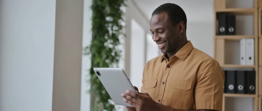 Digital Delight: Capturing a moment of tech-savvy enjoyment, this image features a person engrossed in their digital tablet, finding joy in the blend of modern technology and user experience.
