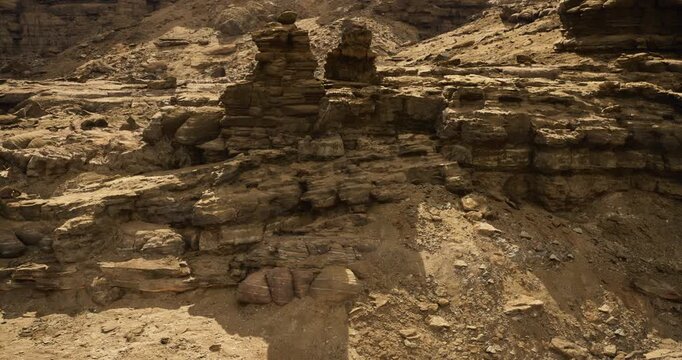 Unique geological formations create a stunning rocky landscape in a remote desert area. The natural textures and layers of rock tell a story of time and erosion in this arid environment.