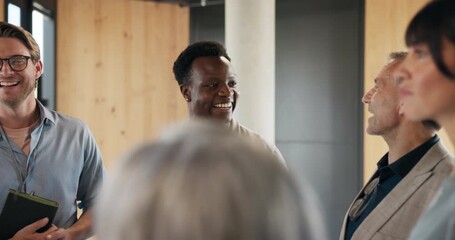 Group, man and notebook with discussion at conference for seminar agenda, schedule and career expo. People, event organizer and keynote speakers in circle for networking, topics insight and planning