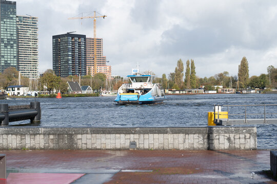 Amsterdam, Netherlands - 27 October 2025: ferry in the IJ bay in Amsterdam public transport GVB. Blue ship boat