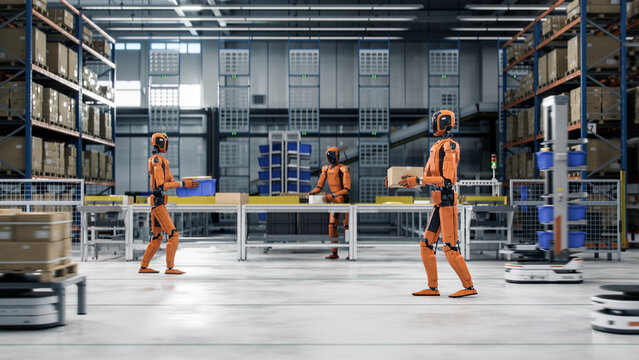 3D Render: Industrial Autonomous AI-Powered General Purpose Humanoid Robots Working at Fulfillment Center. Smart Automated Distribution Warehouse. Industrial Automation with Artificial Intelligence