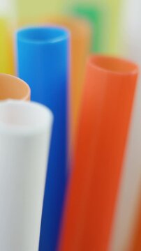 Plastic straws in vivid tones used in vibrant nightlife settings. Serve drinks at poolside bars, clubs and fast food chains. Massive consumption leads to serious ecological damage