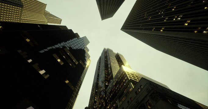 Skyscrapers stretch skyward against a cloudy backdrop. The glass facades reflect the fading evening light, creating a striking contrast with the surrounding structures.