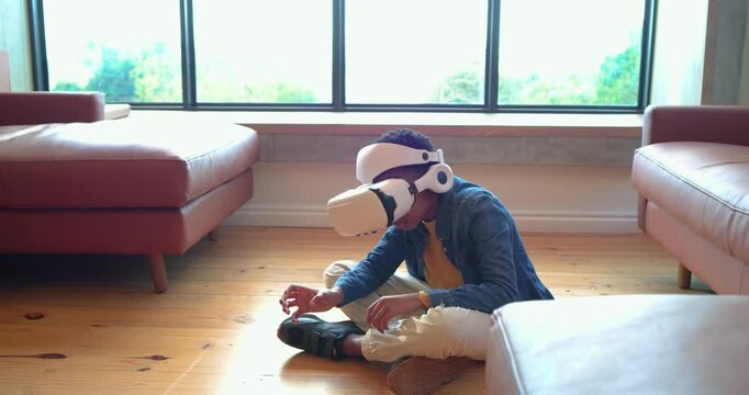 Upon placing white VR headset in living room Black boy exploring VR world while reaching objects