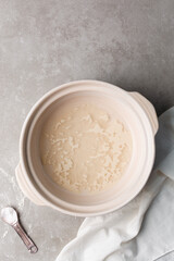 Instant dry yeast sprinkled on warm water, dry yeast granules on water