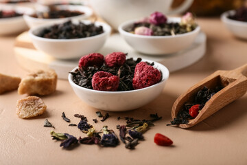 Bowl with dry fruit tea on beige grunge table, closeup