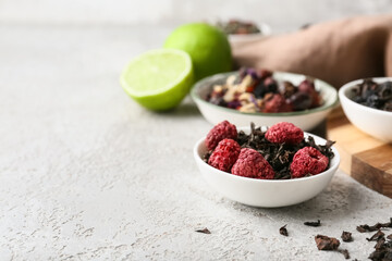 Bowl with dry fruit tea on grey grunge table, closeup