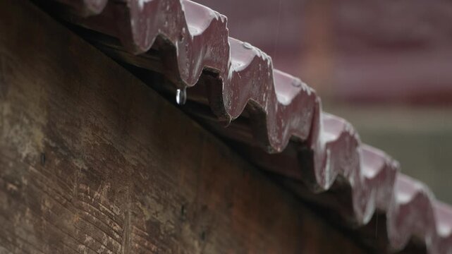 Rainwater Dripping from Roof Tiles During Heavy Rain