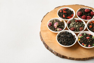 Bowls with different of dry fruit tea on white background, closeup