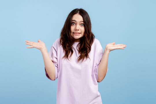 Woman shrugging shoulders, feeling confused and unsure, expressing oops moment