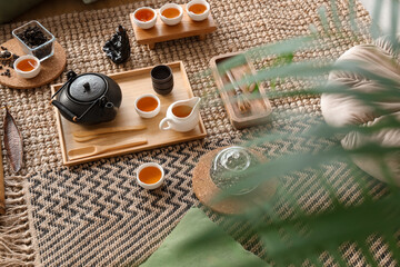 Asian tea set on carpet in room