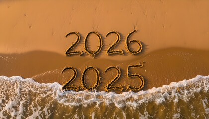 2026 Replaces 2025 Written in Beach Sand: Aerial view of numbers 2026 replacing 2025 as waves wash ashore, symbolizing time, transition, and New Year celebration.