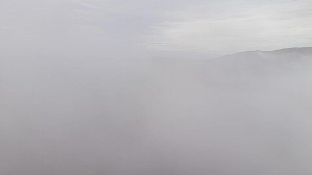soft fog sweeping across valley skyline, coastal pilot navigating low visibility while photographer frames