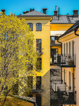 view from fourth floor window into inner courtyard with yellow traditional swedish houses in stockholm