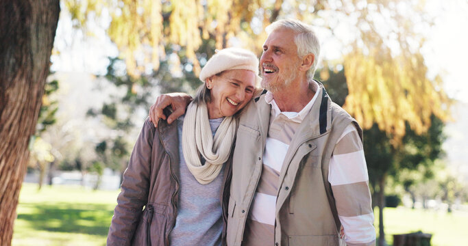 Retirement, walk and couple in park with hug, love and bonding together in happy marriage. Romance, old man or woman in nature with embrace, connection and outdoor stroll in healthy relationship.