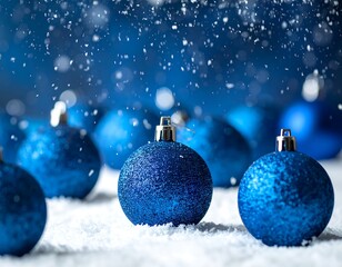 Close-up of blue Christmas ornaments on snow with falling flakes