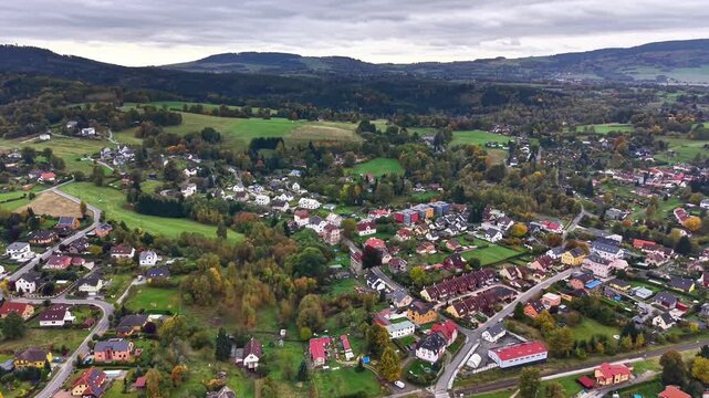skyline village panorama, elevated settlement featuring winding streets and patchy farmland area