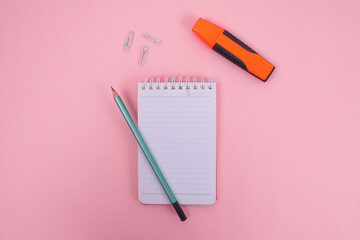 Flat Lay of Student Essentials Yellow and Navy Bag, Notepad, Highlighter, and Colored Pencils