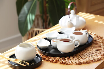 White Asian tea set on table in living room, closeup