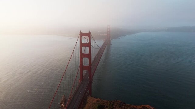 Drone shot of Golden Gate Bridge at dawn during a cloudy day