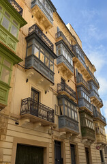 Historic narrow streets lined with houses and balconies in Valletta, Malta
