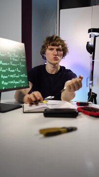Young biohacker tests experimental wearable technology at home connecting sensors to his arm studying bioelectronic signals human performance and personal body data through hands on research