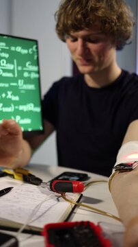 Vertical screen biohacker tests wearable microchip and sensors at home lab recording data writing notes and exploring human enhancement biohacking self optimization and future technology