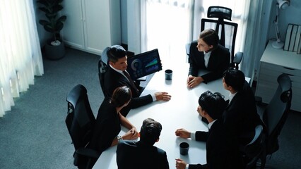 Top view of project manager present increasing sales chart while diverse group analysis financial investment data. Group of smart investors discuss marketing plan and solve the problem. Directorate.