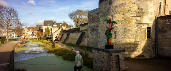 Christmas decorations in the historic streets of Dutch town Valkenburg with city wall in the background