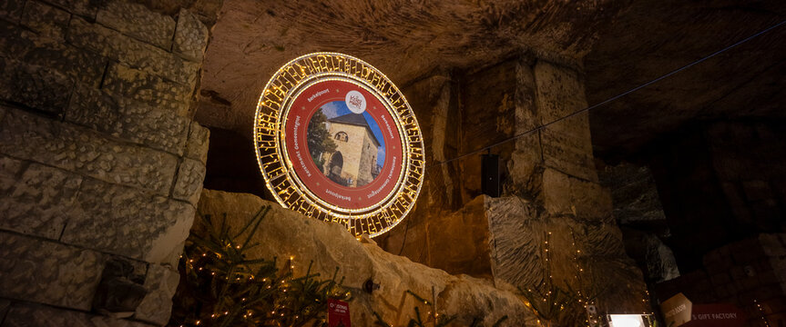 Emblem with information board during Christmas market Kerstmarkt in mining cave Gemeentegrot in Dutch town Valkenburg