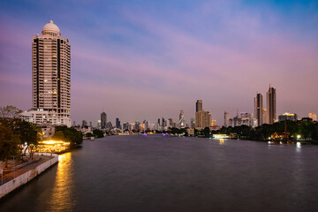 View of Chao Phraya River from Chao Phraya Sky Park. Bangkok cityscape at sunset (blue hour).