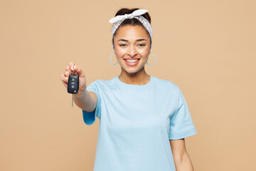 Young smiling woman of African American ethnicity wearing blue t-shirt casual clothes hold in hand...