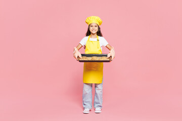 Full body small happy kid child girl housewife chef cook baker mother helper wear yellow apron...