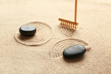 Fotobehang Zen Stenen Black spa stones and rake on light sand with pattern. Zen concept  © Pixel-Shot
