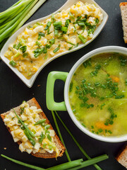 Homemade dinner healthy chicken broth with veggies and egg salad sandwiches for cold season.