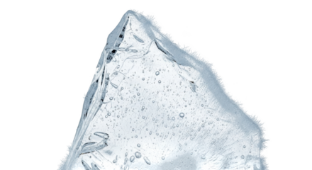 Clear ice shard with air bubbles and frosty edges on black frozen cold