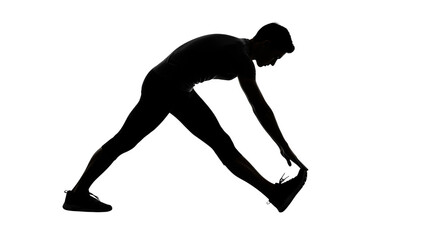 Man stretching hamstrings in silhouette against black background hamstring stretch