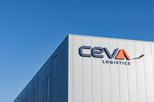 Large logo of CEVA Logistics on the facade of a distribution center warehouse against a blue sky. Supply chain and freight company brand. Nieuwegein Netherlands, 21 November 2025.