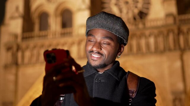 Smiling african american tourist taking pictures in paris