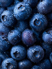Freshly harvested blueberries with water drops, blue fruit wallpaper for phone.
