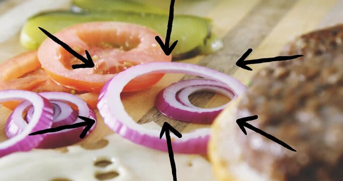 Burger being animated camera shifting right, bun entering, settling, arrows highlighting toppings