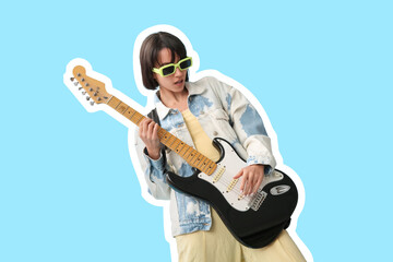 Cool young woman playing electric guitar on blue background