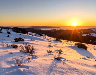 Snowy hillside at sunset over a valley