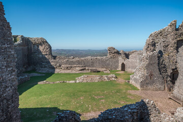 The ruin of Carreg Cennen Castle sited on a high rocky outcrop in Carmarthenshire, Wales on a sunny day