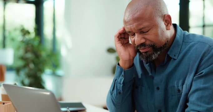 Black man, fatigue and laptop in office with headache for copywriting mistake, marketing crisis or issue. Exhausted, mature person and computer with migraine, advertising problem or copywriter error.