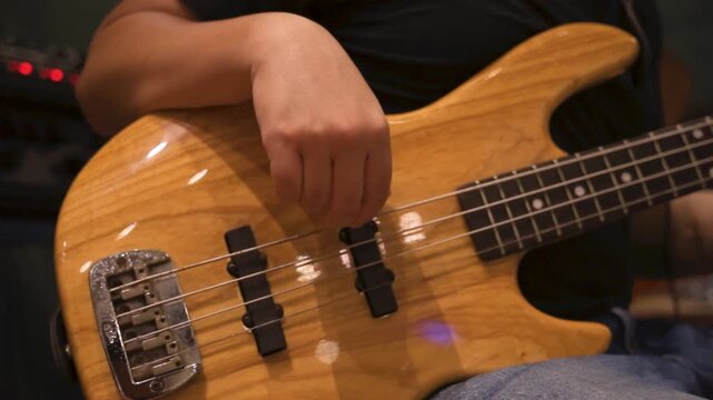 Close up musician playing bass in reheasal studio